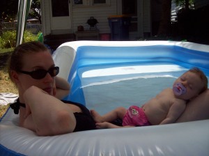mom and sleeping baby in inflatable pool