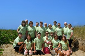family on beach matching green tee shirts